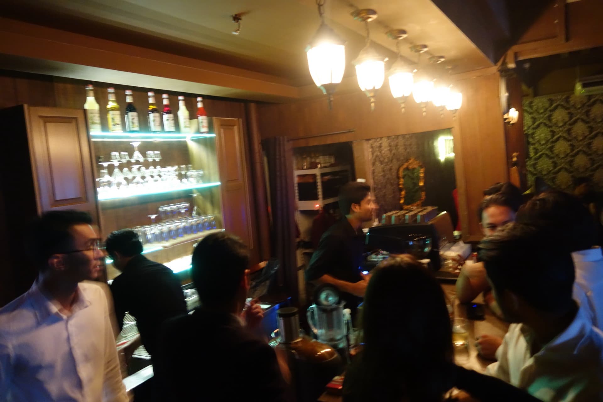 The early JIBRIL bar in SS15, guests at the counter under lantern light.
