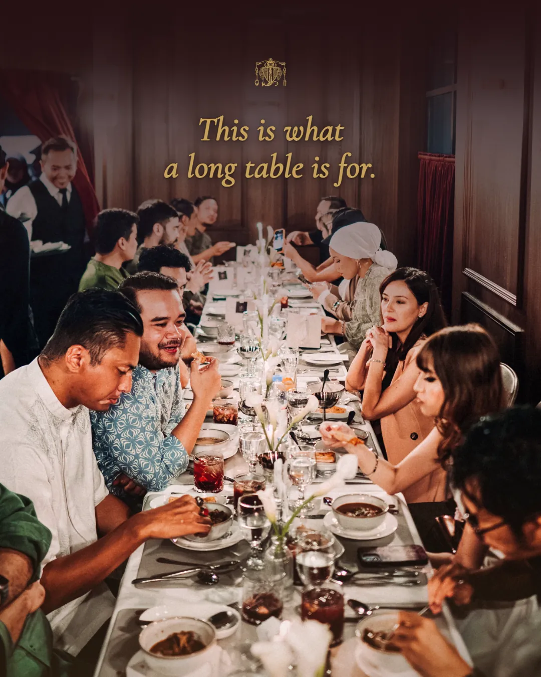 Guests sharing a meal at a long table at JIBRIL. This is what a long table is for.